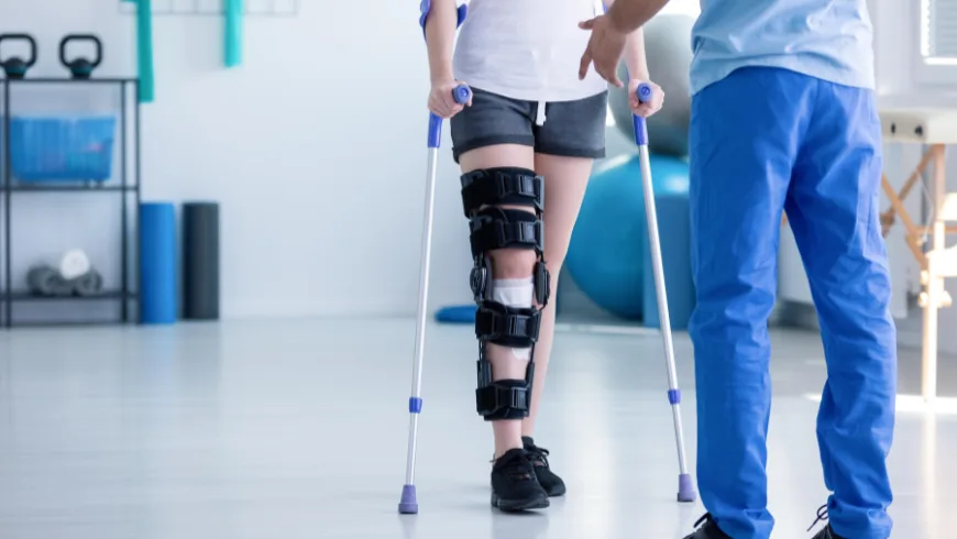 Physical therapist guiding a patient through post-surgical injury rehabilitation exercises. post-surgery physiotherapy Birmingham