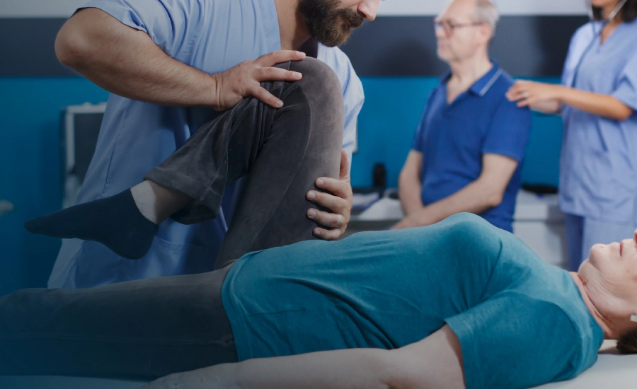 A doctor examines a man, assessing his musculoskeletal health in a clinical setting sciatica specialist physiotherapist Selly Oak