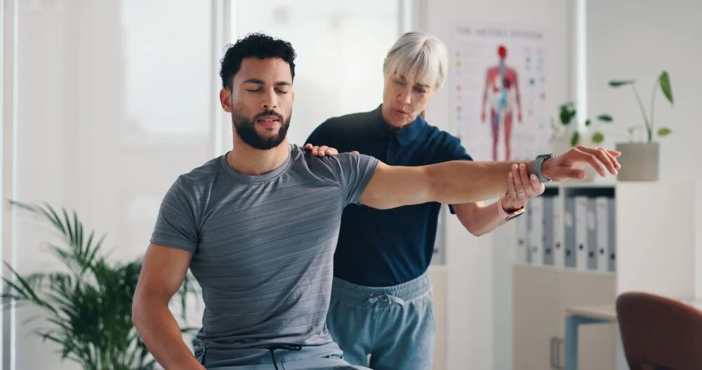 Patient performing targeted physical therapy exercises under the guidance of a rehabilitation specialist sports injury clinic Birmingham post-surgery physiotherapy Birmingham ACL rehab Birmingham